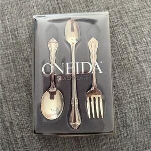 Unopened new with tag Oneida silver plate baby set